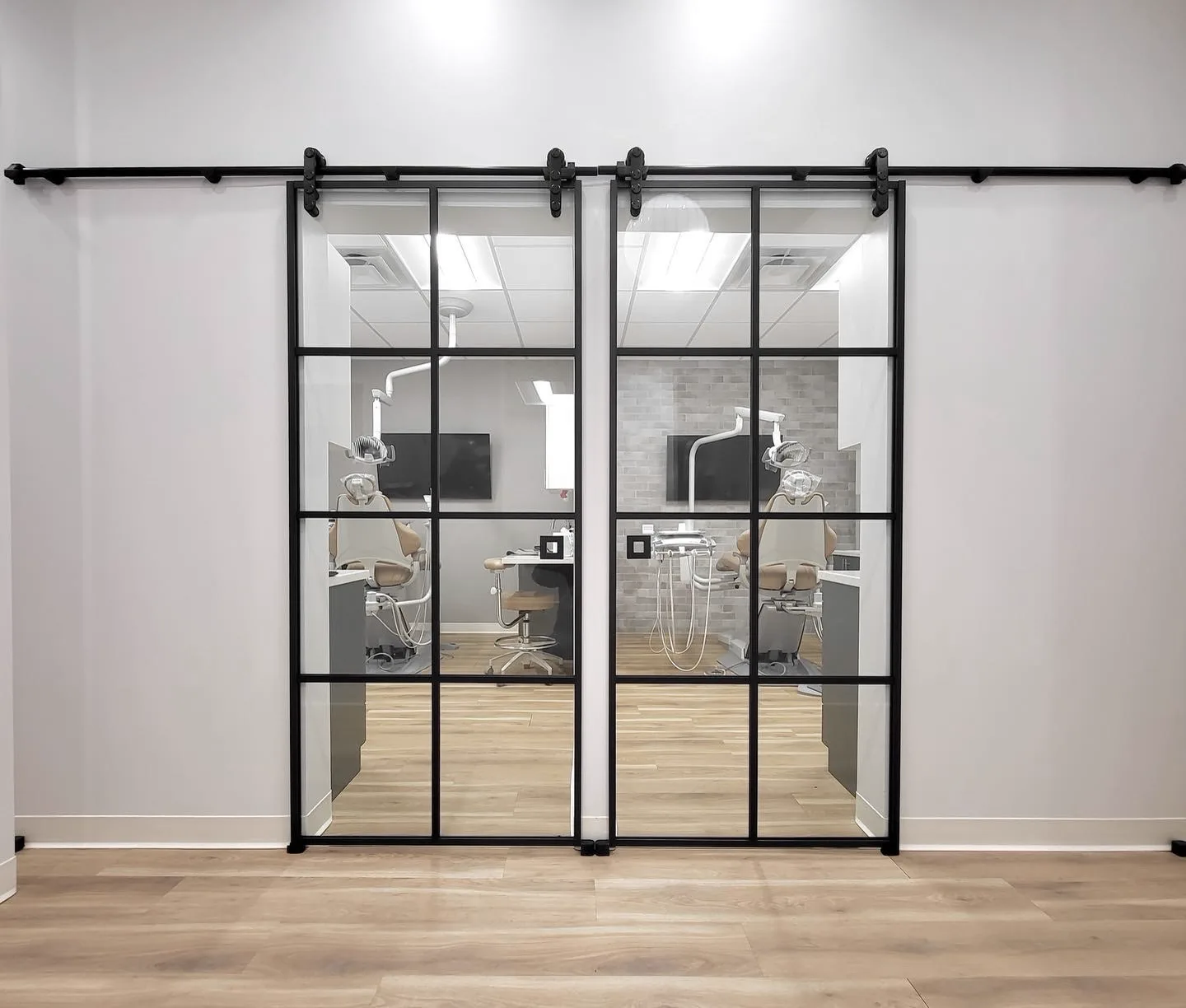 Dental office barn-style sliding glass doors by WiseGlass NY