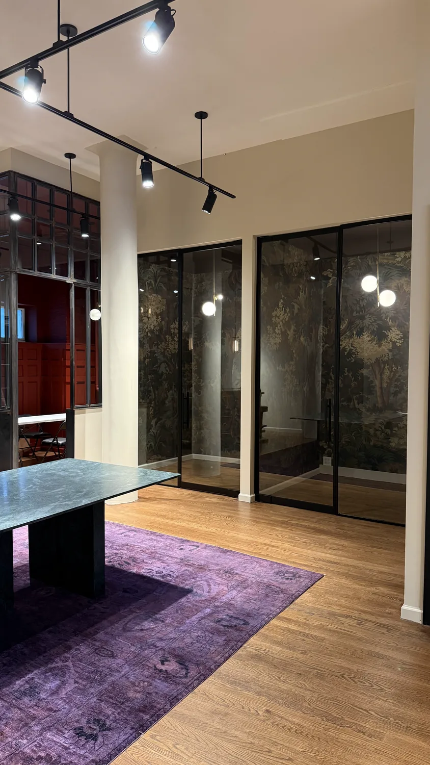Full-height smoked glass office partitions with full-height doors over a hand-painted mural, Manhattan by WiseGlass NY