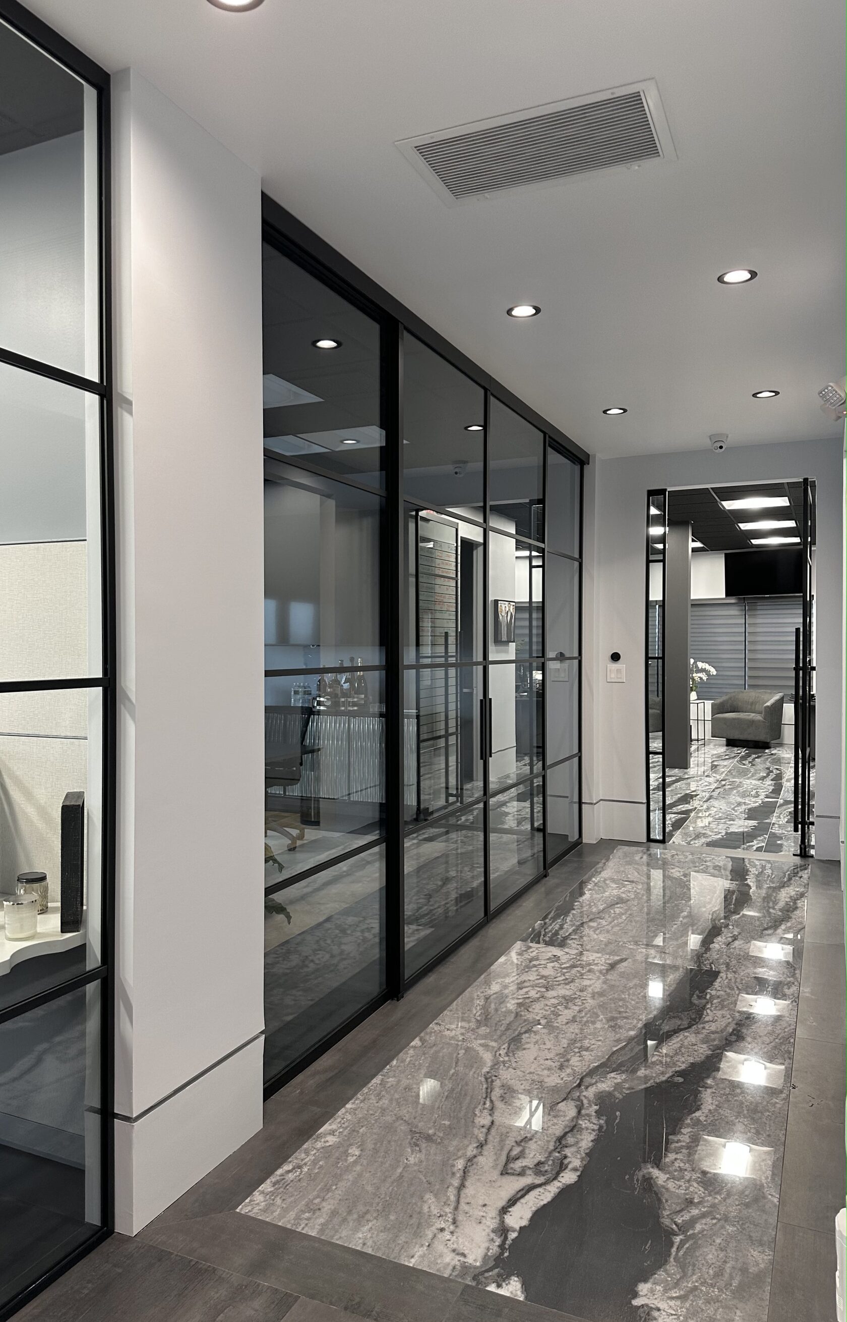 Black-framed glass partition dividing a loft living area