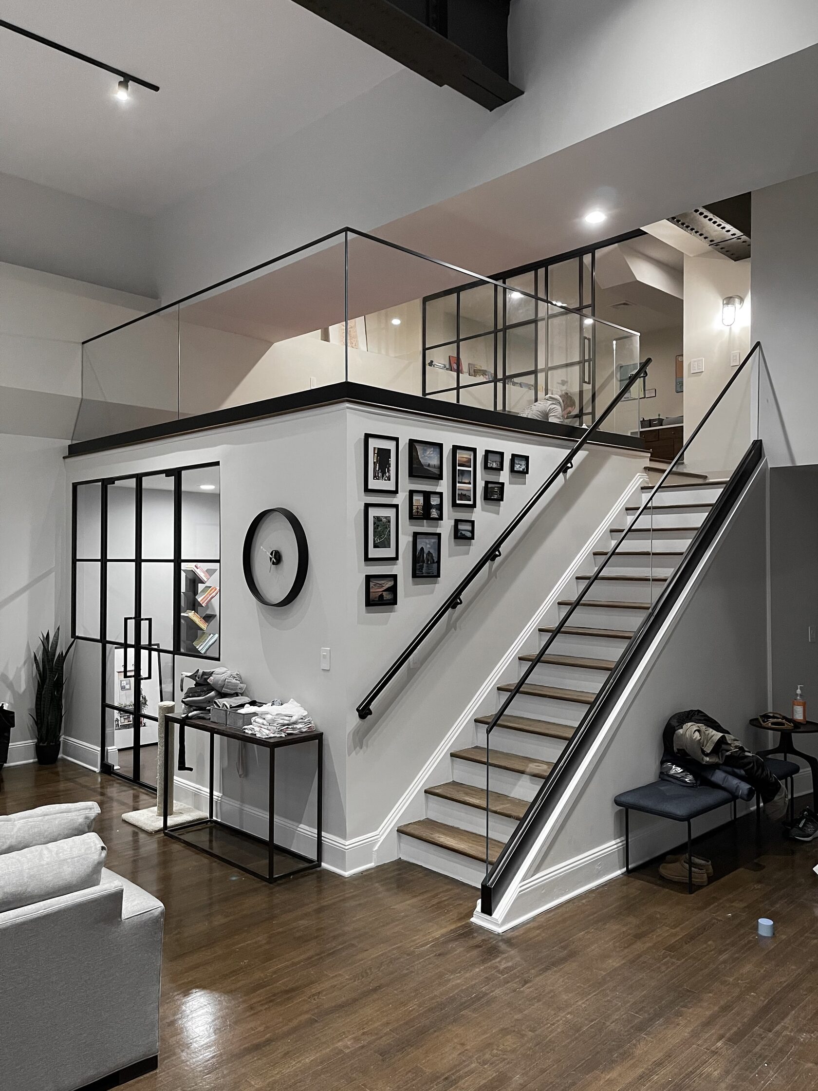Glass partition wall with slim black frames in a residential interior