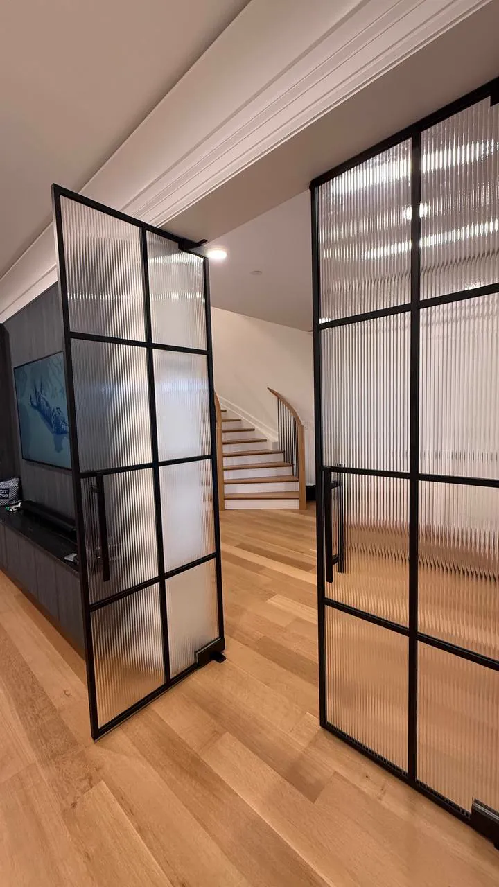 Black-framed reeded glass French doors seen down an upstairs hallway, Allenhurst NJ by WiseGlass NY