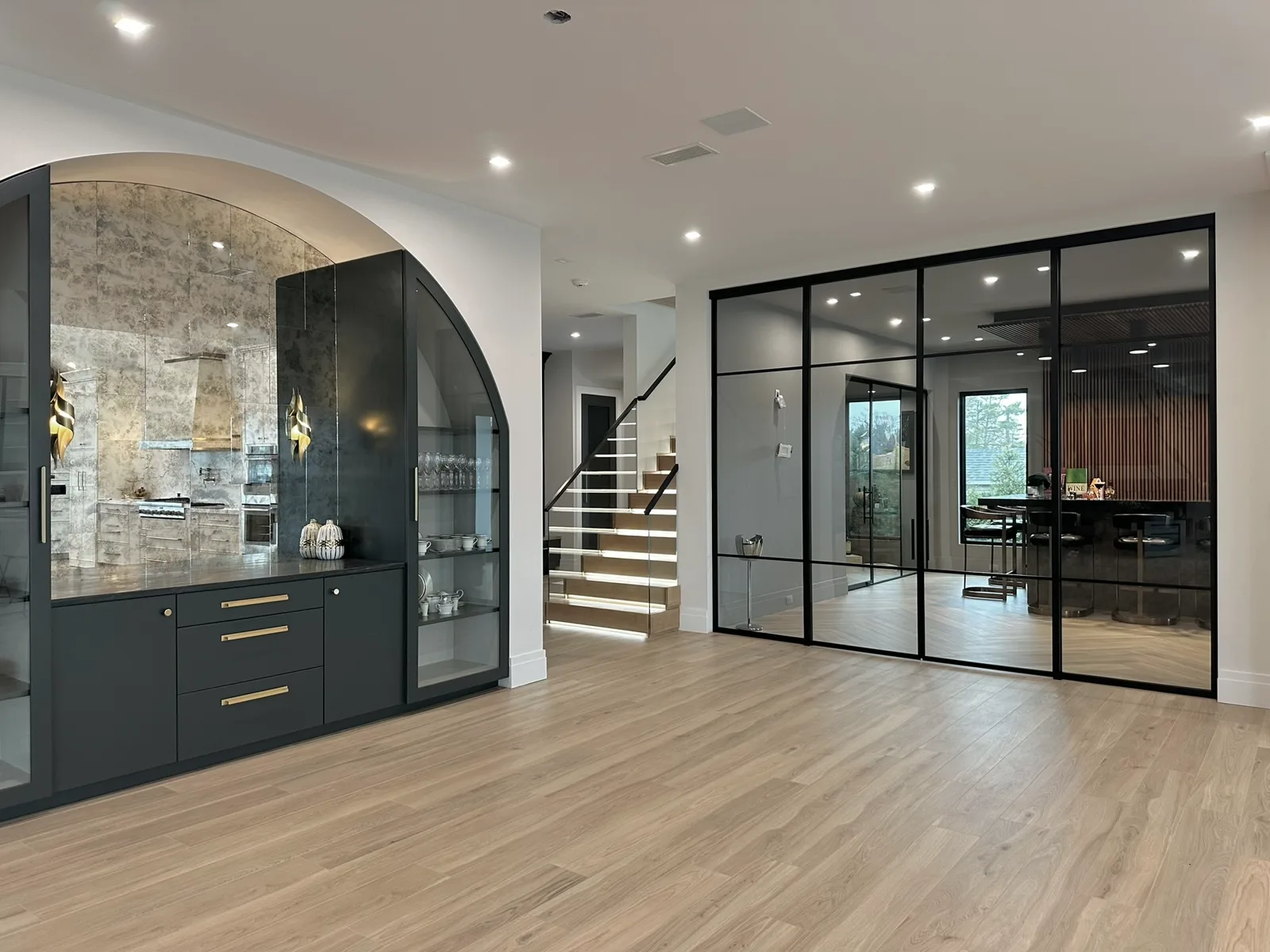 Double-sliding black matte aluminum-framed glass partition with center grid design, East Islip NY estate — WiseGlass NY