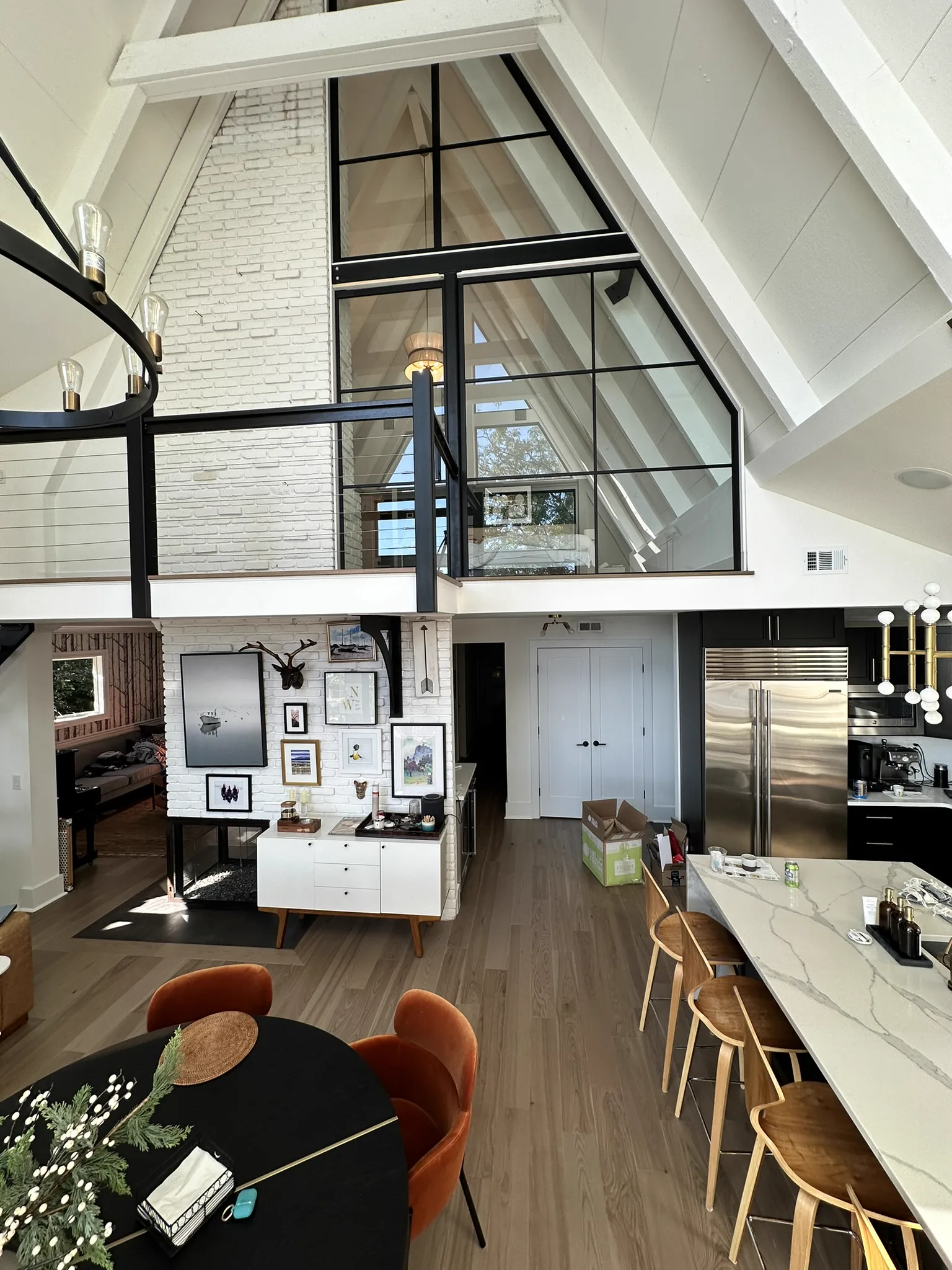 Full interior view of A-frame beach house showing attic glass partition from main floor — WiseGlass NY