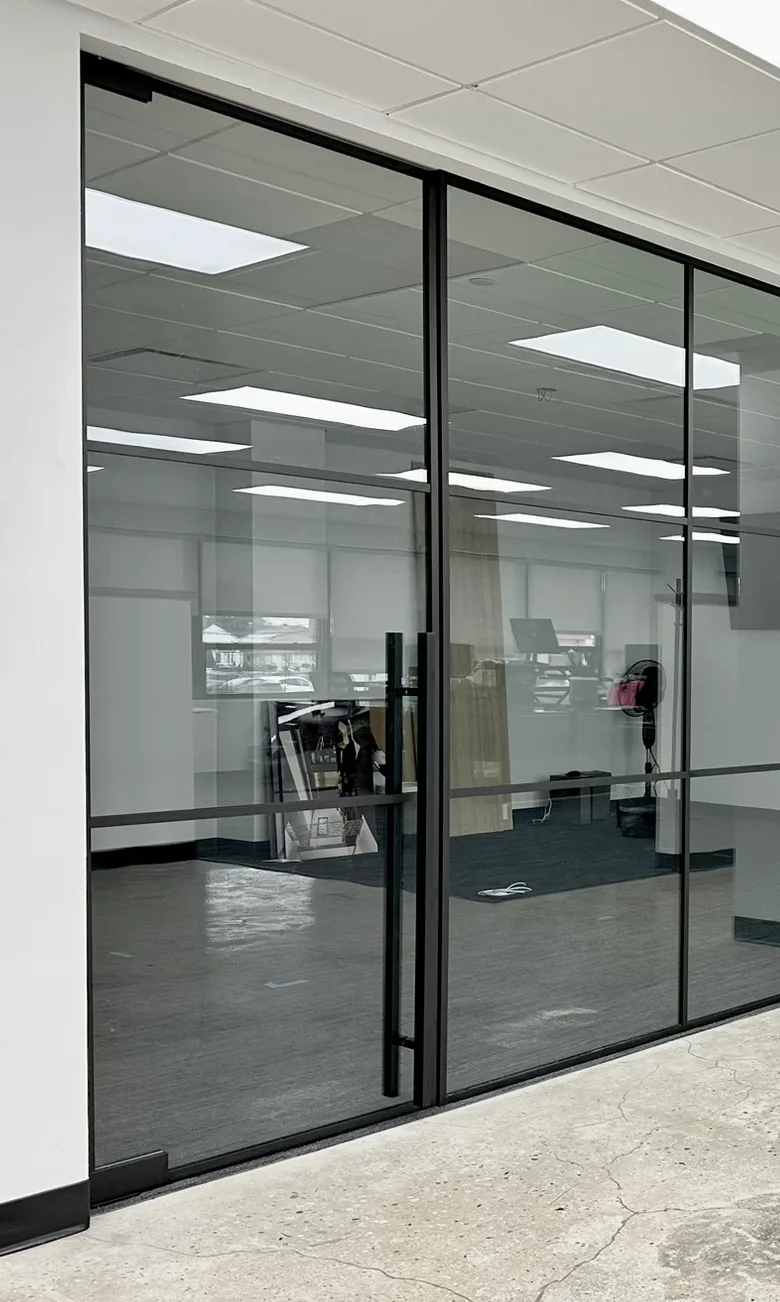 48-inch commercial bar door handle on black matte glass partition — WiseGlass NY, Rosedale NY