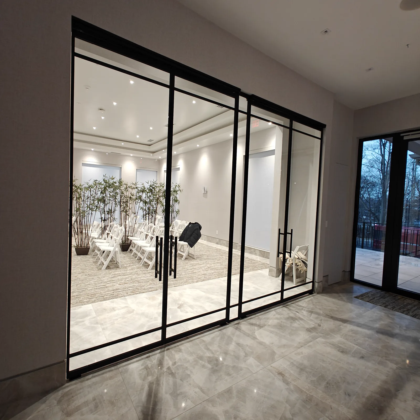 Custom tall black matte French doors with center sidelight for synagogue entrance — WiseGlass NY