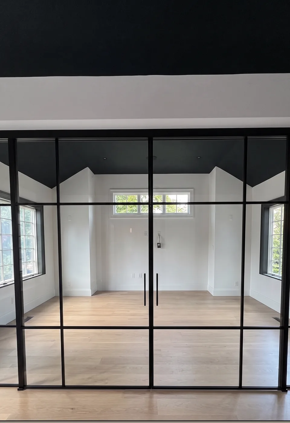 Custom grid glass partition aligned to the divided lite windows behind it, upstate New York by WiseGlass NY