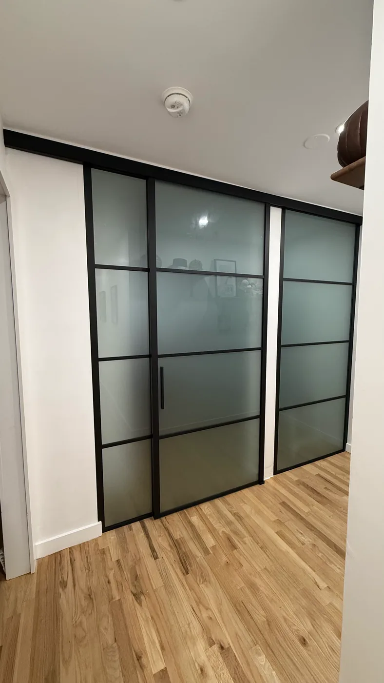 Three panel frosted glass barn style sliding wall on an exposed black track, Manhattan by WiseGlass NY