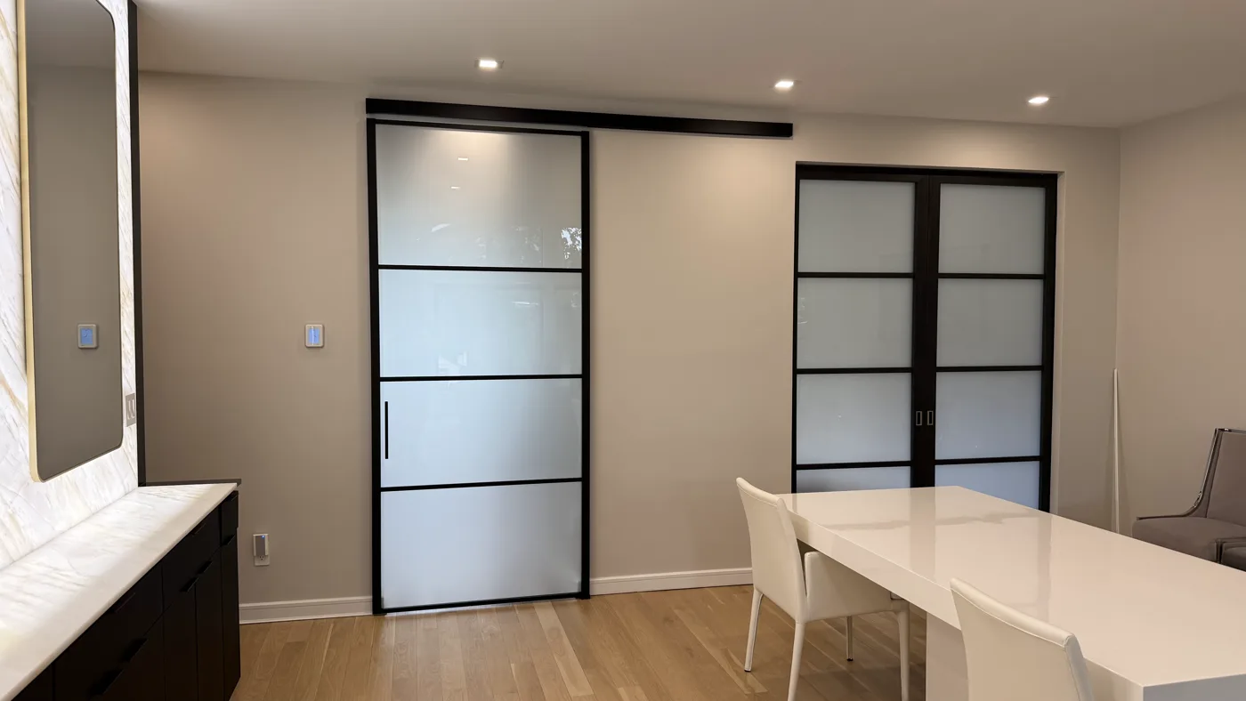Frosted glass barn-style sliding door matching existing French doors, by WiseGlass NY