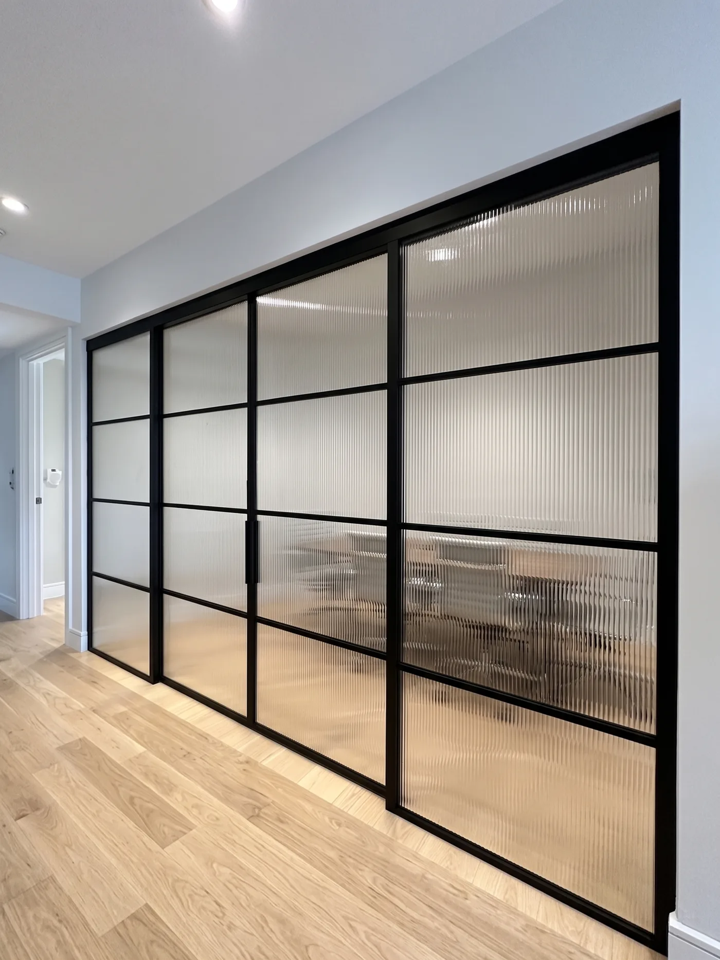 Concept rendering: double sliding configuration with reeded glass for office privacy